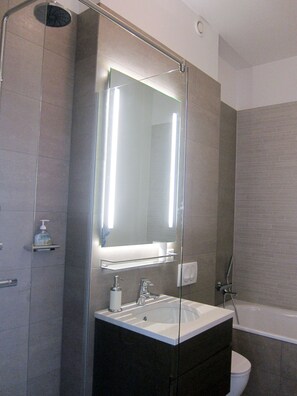 Bathtub, hair dryer, towels, soap