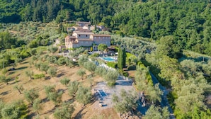 A large estate with multiple buildings, a swimming pool, and a river. - Tuscan Fizz, a traditional Stone Farmhouse with Private Pool and Amazing View among the Vineyards in Lucca (Lucca)