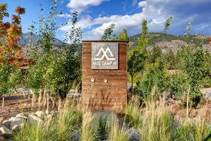 A sign for 'BASE CAMP 49' with a mountainous backdrop.