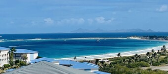 Duplex with frangipani tree, view of Saint Barthelemy, Baie Orientale beach
