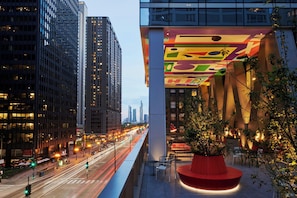 A modern building with a colorful facade and a red circular seating area.