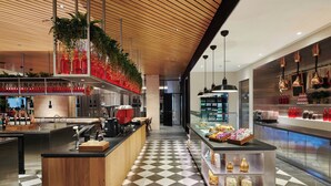 A modern bar area with a checkered floor, wooden ceiling, and various bar equipment.