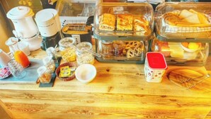A breakfast buffet with various food items and condiments.