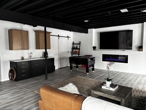 Smart TV, fireplace, table football, books