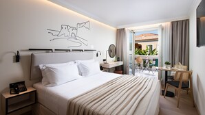 Une chambre d’hôtel avec un lit, une table de chevet et vue sur le balcon extérieur.