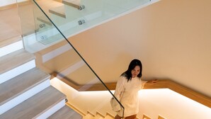 Un escalier moderne avec des rampes en verre et des marches en bois.