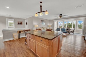 Enjoy meals in the kitchen with a large island, high ceiling, and dining area.