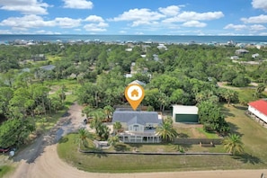 Enjoy scenic views from this single-story house surrounded by lush greenery and palm trees.