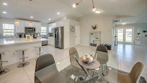 A modern kitchen with a central island, stainless steel appliances, and pendant lighting.