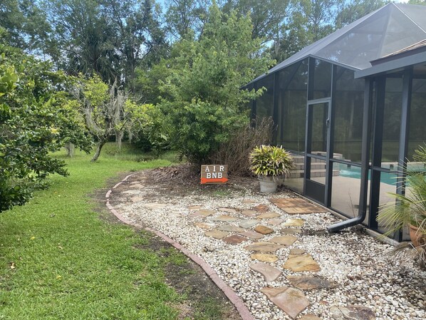 A house with a pool, surrounded by a garden with a stone pathway leading to the entrance. - 2 Bedroom Suite (Port Orange)