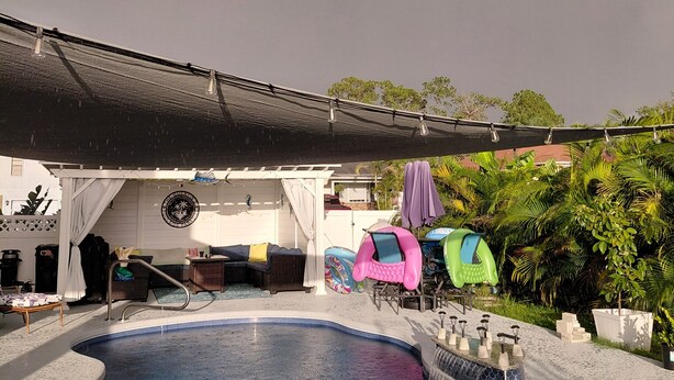 A swimming pool with a covered area and lounge chairs. - We are the coolest hosts on the planet! You will love it here!  (Holiday)