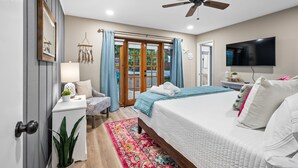 A bedroom with a bed, a desk, a chair, a ceiling fan, a TV, and a window with curtains. - Sunny Palms Villa - Heated Pool + Hot Tub, 2 miles to the Beach! (Fort Lauderdale)