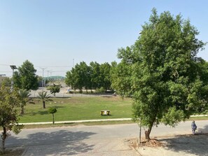 Stroll through the serene park, surrounded by lush greenery and a well-maintained lawn.