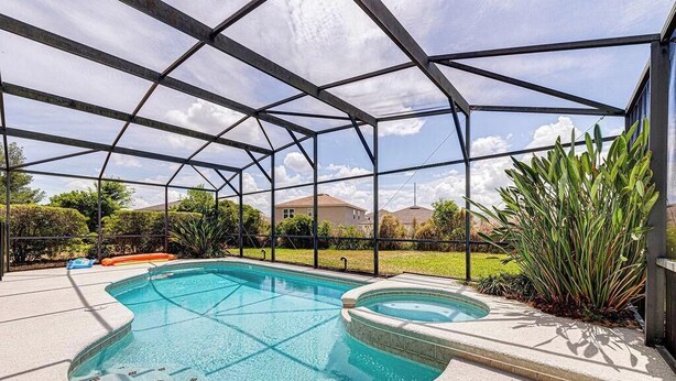 A covered swimming pool with a clear view of the surrounding area. - Gorgeous 4 Bedroom, Disney And South Facing Pool (Davenport)