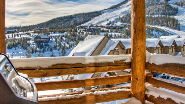 A snowy mountain village with wooden buildings and a clear sky. - Ski-In/Ski-Out Chalet | Lone Peak Views | Private Hot Tub (Big Sky)