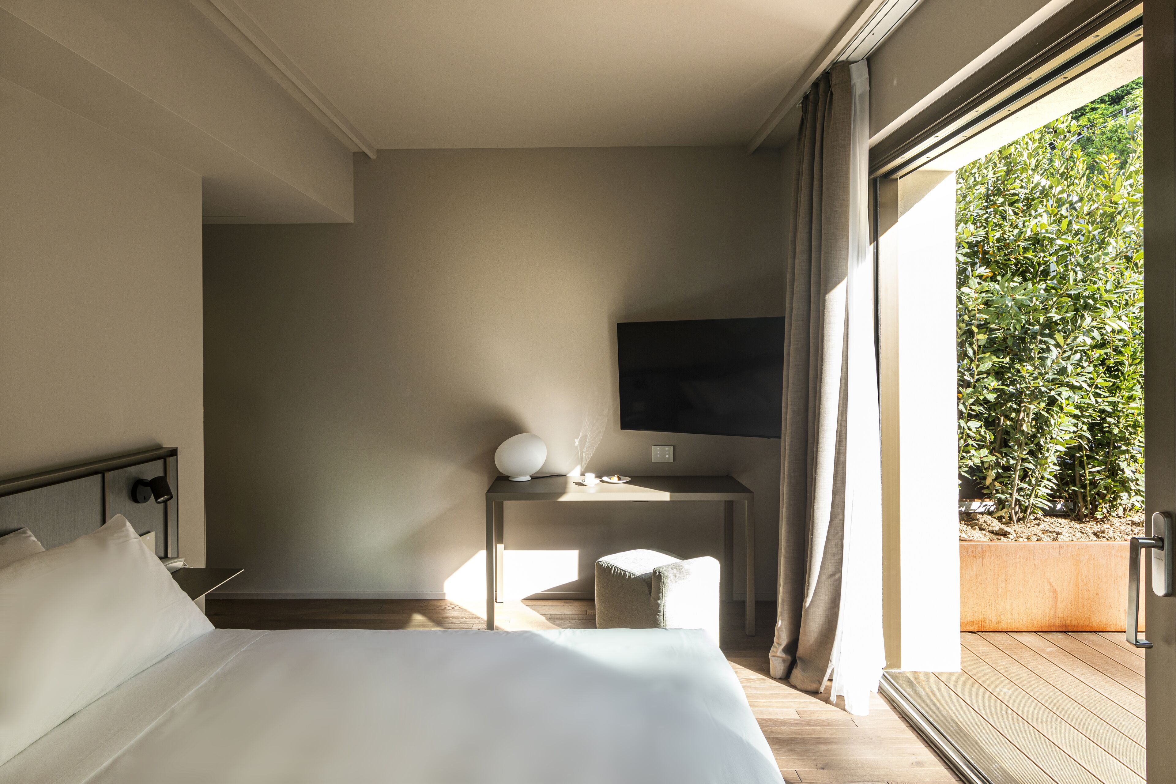 Een slaapkamer met een bed, een bureau, een stoel en een televisie.