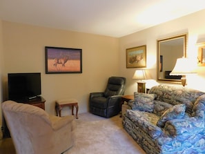 Relax in this inviting living room with a sofa, TV, and comfortable seating.