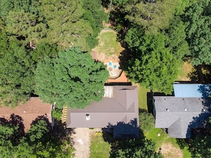 Residential homes with diverse roof styles and lush green surroundings.