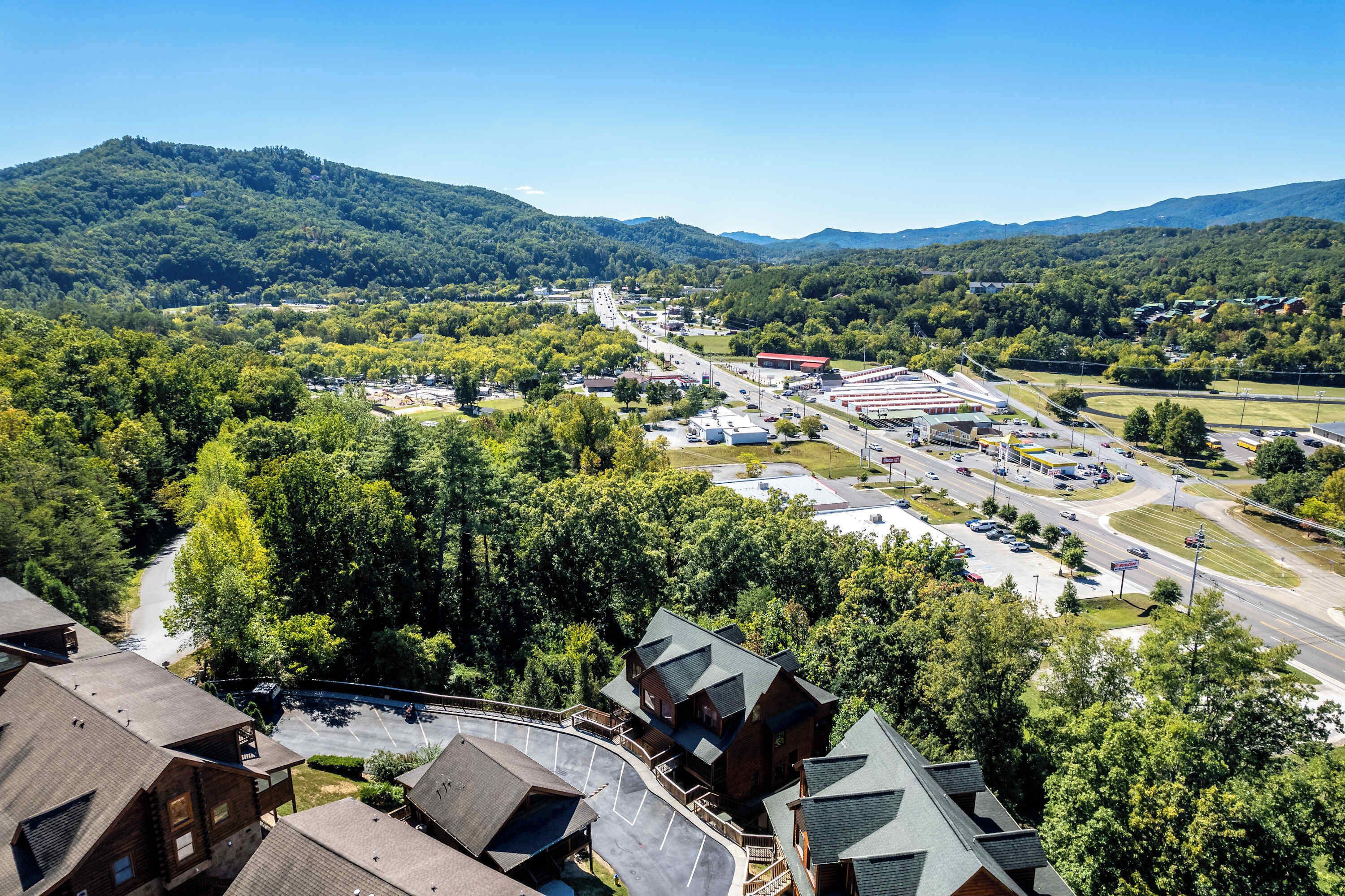 A town with a main road, buildings, and a mountain in the background.