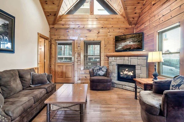Our living room with a big comfy couch, Smart TV, fireplace, and some extra seating!
