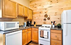 Enjoy cooking in this well-equipped kitchen with a central island, microwave, coffee maker, and stove.