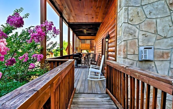 Relax on the deck with a comfortable seating area and lush surroundings.