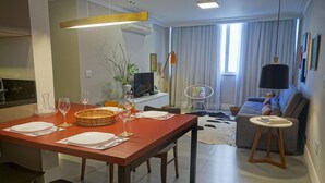 A modern living room with a dining area, a sofa, a TV, and a fan. - Modern in Ipanema Great for Families Re406 Z2 (Rio de Janeiro)