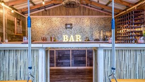 A rustic bar area with a wooden ceiling, a mosaic wall, and shelves with decorative items. - NEW! 5 BED/5 MIN TO BEACH/HTD POOL/HOT TUB/BAR (Oakland Park)