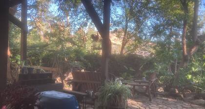 Cottage nestled in trees and goldfish ponds