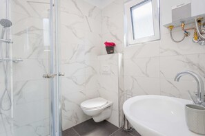 Shower, hair dryer, towels, toilet paper