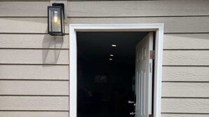 A doorway leading into a room with a dark interior, a door with a handle, and a small step with a doormat. - Great Lower Unit with Spacious Yard and Sunroom (Denver)