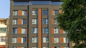 A modern hotel building with a prominent sign for Gursoy Exclusive Hotel. - Gursoy Exclusive Hotel (Arsin)