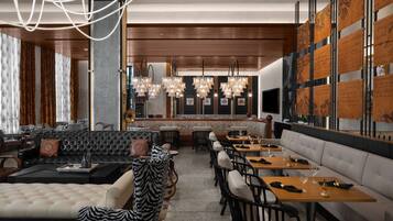 Un ristorante moderno con zona bar, sedute in pelle e una parete ampia con pannelli decorativi.