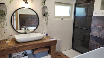 Bathtub, hair dryer, towels, toilet paper
