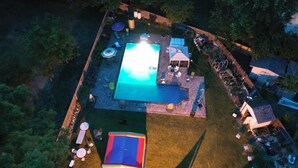 An aerial view of a backyard with a swimming pool, outdoor furniture, and a tent. - The Jahmtons Guest Room (Ridge)