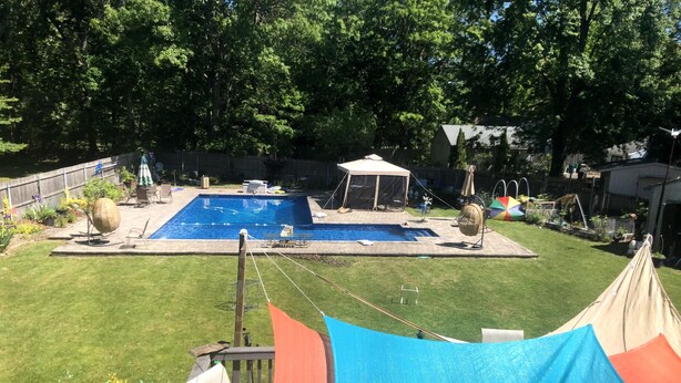 A backyard with a swimming pool, a covered seating area, and a tent. - The Jahmtons Guest Room (Ridge)