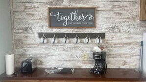 A kitchen counter with a coffee maker, a toaster, and a mug rack with six mugs. A sign above reads "together is my favorite place to be." - FS Rental #2 Annapolis, MO Black River (Annapolis)