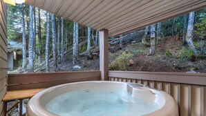 A hot tub in a wooden deck with a view of a forested area. - 3BR | Whistler Creek Ridge | Ski-in/out | Private Hot Tub | Wood Fire | Private Garage (Whistler)