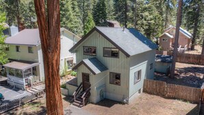 A two-story house with a front porch, a small attached garage, and a fenced backyard. - Short Walk 2Tahoe~Family~Beach~Kings Beach Retreat (Tahoe Vista)
