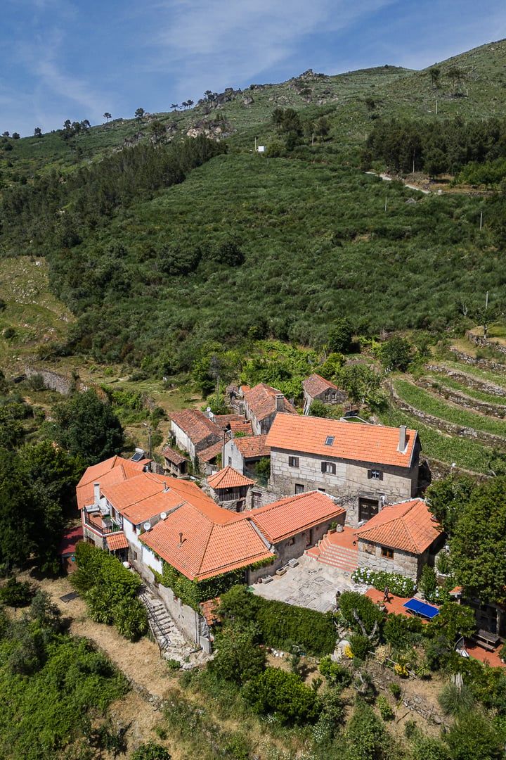 A hillside village with traditional stone houses and terraced fields.