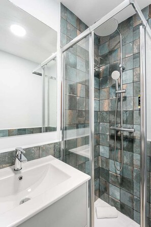 Shower, hair dryer, towels, soap