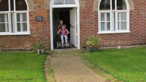 A brick cottage with a sign reading "Stables Cottage." - Stables cottage - fully accessible with you in mind (Norwich)
