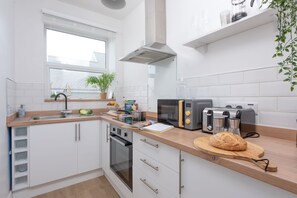 Enjoy cooking in this kitchen with oven, toaster, and coffee maker.