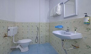 A bathroom with a toilet, sink, and shower.