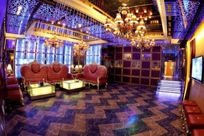 A luxurious lobby with ornate chandeliers, plush seating, and a patterned floor. - Tianma Hotel (Wuwei)
