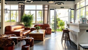 A spacious lobby with leather sofas, a coffee table, and a bar area. - Hersy Vista · Hesi 270° Panoramic Erhai-Cangshan View Boutique Stay (Dali City)