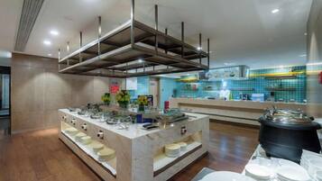 A modern kitchen with a central island, stainless steel appliances, and a tiled backsplash.