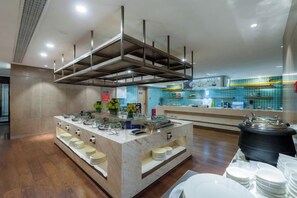 A modern kitchen with a central island, stainless steel appliances, and a tiled backsplash. - Chengtou Gangwan Hotel (Zunyi)