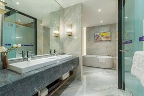 A modern bathroom with two sinks, a large mirror, a bathtub, and a glass shower enclosure. - Chengtou Gangwan Hotel (Zunyi)