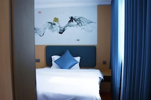 A hotel room with a bed, a headboard, a wall with a painting, and a window with curtains. - Beiliu Grand Hotel (Guijiang Pearl Pedestrian Street) (Beiliu)